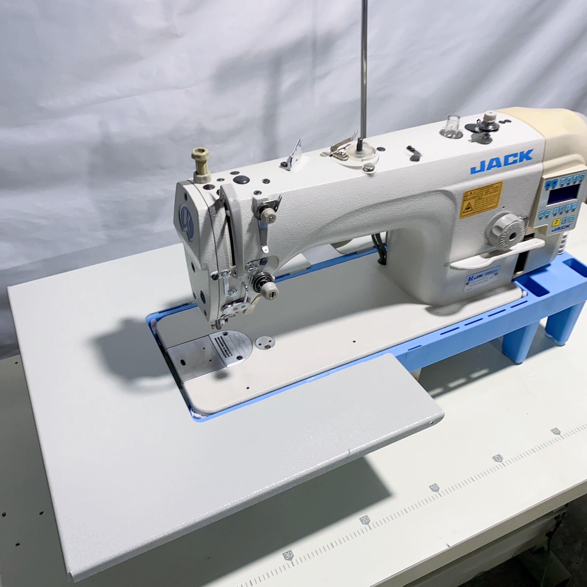 A computerized direct-drive lockstitch machine: the basic unit of the modern industrial sewing machine