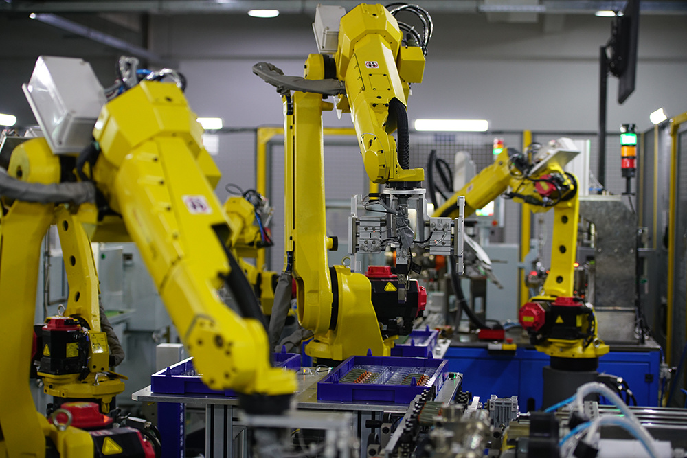 Industrial robots on an automated motor assembly line